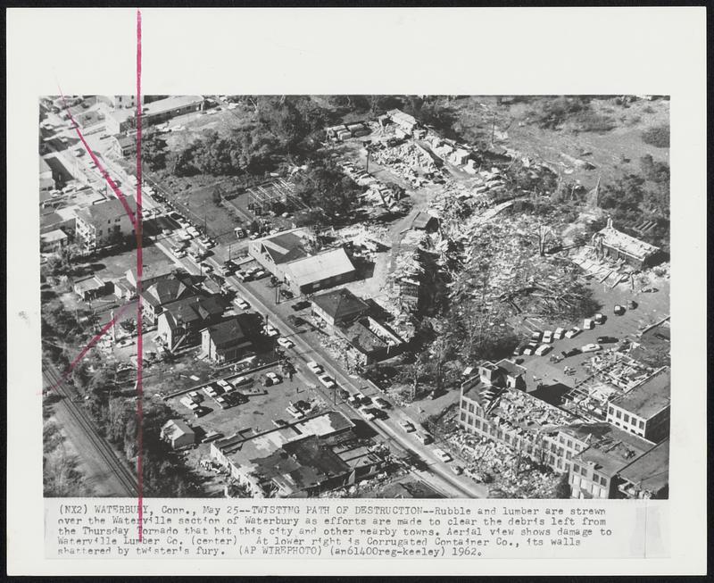 Twisting Path of Destruction--Rubble and lumber are strewn over the Waterville section of Waterbury as efforts are made to clear the debris left from the Thursday Tornado that hit this city and others nearby towns. Aerial view shows damage to Waterville Lumber Co. (center) At lower right is Corrugated Container Co., its walls shattered by twister's fury.