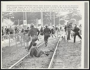 Police chase dissident students out of the San Francisco State College campus and up 19th and Holloway St. here 12/2.One of the students(foreground on ground)is apparently in no condition for further running. Trouble on the campus began earlier when Acting President S.I. Hayakawa tried to reopen classes today.