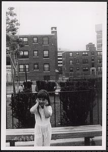 Girl covering her ears outside Newtowne Court