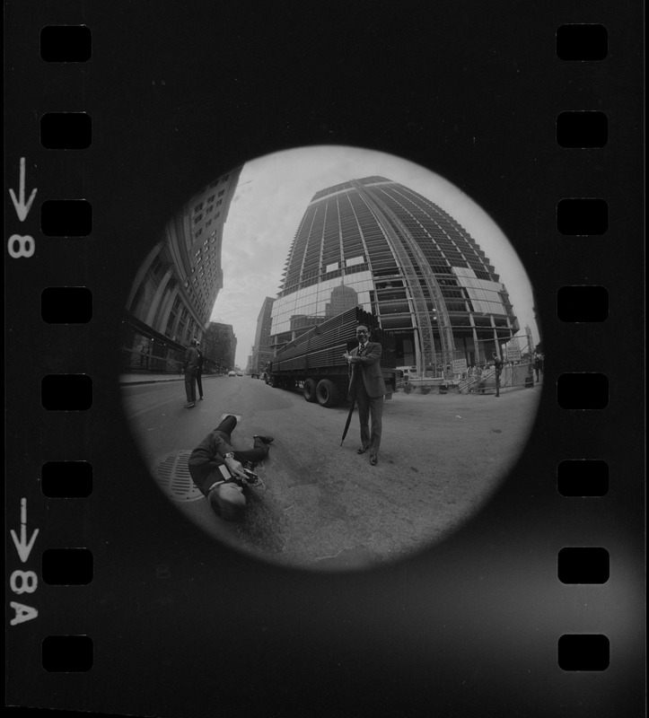 I.M. Pei seen being photographed in front of the John Hancock Tower while under construction