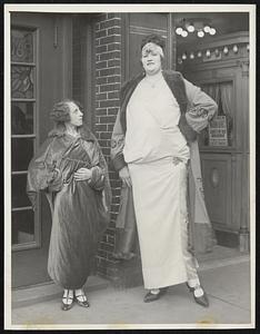 Looking Up At The World’s Tallest Woman. Mme. Lendy - never has to climb on a chair to reach her band box - for she is 7 ft. 6 in. in height. She must chose her chair carefully for she weighs 300 pounds. She is quite a world traveler, but at present is enjoying Brooklyn, N.Y.