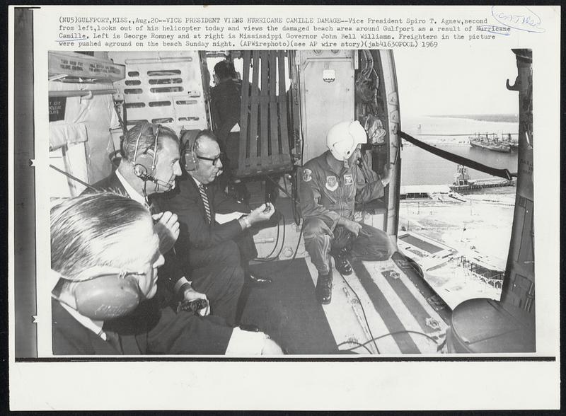 Gulfport, Miss. -- Vice President Views Hurricane Camille Damage -- Vice President Spiro T. Agnew, second from left, looks out of his helicopter today and views the damaged beach area around Gulfport as a result of Hurricane Camille. Left is George Romney and at right is Mississippi Governor John Bell Williams. Freighters in the picture were pushed aground on the beach Sunday night. Weather.