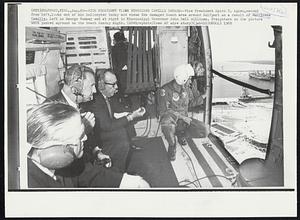 Gulfport, Miss. -- Vice President Views Hurricane Camille Damage -- Vice President Spiro T. Agnew, second from left, looks out of his helicopter today and views the damaged beach area around Gulfport as a result of Hurricane Camille. Left is George Romney and at right is Mississippi Governor John Bell Williams. Freighters in the picture were pushed aground on the beach Sunday night. Weather.