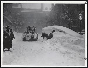 Operation Towcar goes into action during the height of the storm on Chestnut St., Beacon Hill. The quaint old streets of Beacon Hill are no place for an auto in a blizzard.