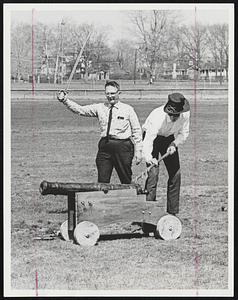 Ready...Aim...Fire! Granville Rideout of Ashburnham (with sword in hand) directs the firing of the four-pound cannon that won the Brockton Symphony Orchestra audition to be heard during the "1812 Overture." Louis Ploucquet, of Canaan, N.H., does the actual firing.