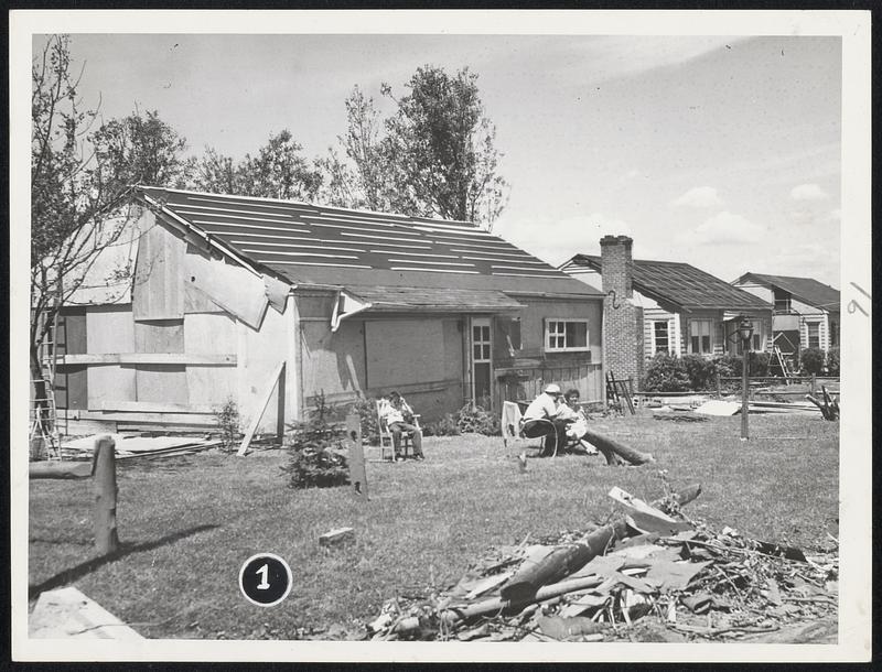 These houses in Holden with roofs repaired with tar paper.