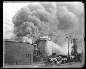 Firefighters using water hoses on an unidentified fire