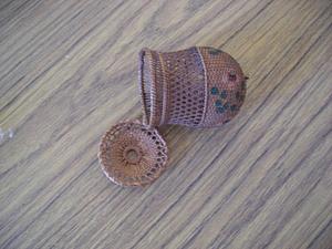 Small cylindrical basket with rounded base and attached lid