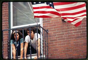 Boston - N. End 1981: With an American flag flying, a man and woman watch St. Anthony's Feast