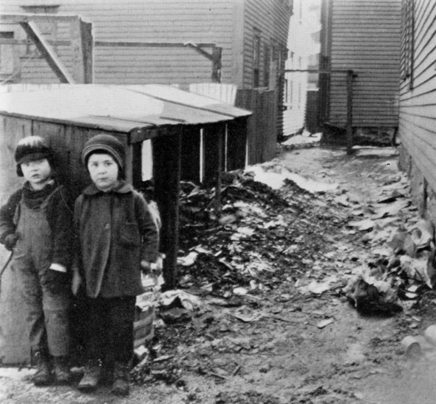 Two children in a typical alleyway between tenements