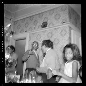A blurred photograph of four people standing