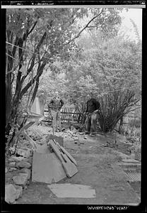 Two men in backyard of 5 Tucker Street in springtime