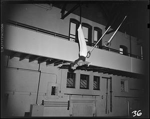 SC gymnast dismounting from the flying rings