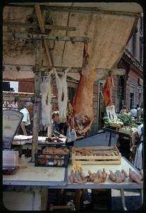 Butcher at outdoor market, Rome, Italy