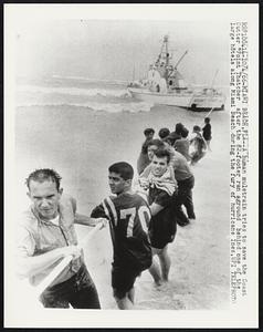 Miami Beach, Fla. -- A human muletrain tries to save the Coast Cutter “Point Thatcher after the 82-footer ran aground behind one of the large hotels along Miami Beach during the fury of hurricane Inez.