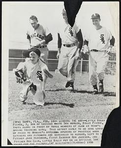 Leading the Law--Little Billy Pierce, 2, son of Chicago White Sox hurler, Billy Pierce, trots along in front of three members of club at team's spring training site. Trio got out early to do some loose up prior to Monday's official opening of practice when catchers and pitchers are scheduled to report. Left to right are Pitcher Jack Harshman, First Baseman Ron Jackson, and Pitcher Bob Cain. Little Billy put on an official Sox shirt for the picture.