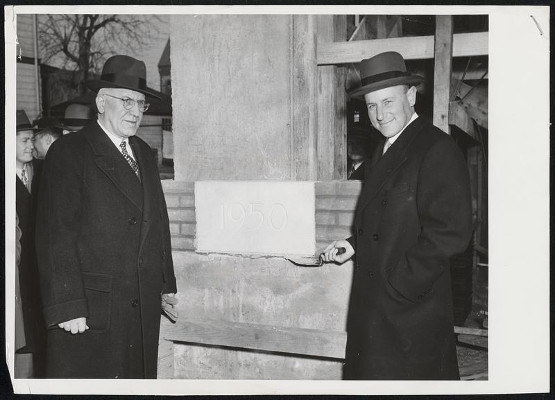 Newton's Mayor, Theodore R. Lockwood, and Raytheon's President, Charles Francis Adams, Jr. , (left to right) laying the cornerstone for Raytheon's new $100,000 cafeteria at the Chapel Street Raytheon Tube Plant in Newton, Mass.