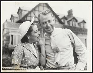 Paul Runyan (right) of White Plains, N. Y., former P. G. A. champion, was another. The gallery was hushed to a whisper when Runyan sank a 125-yard mashie niblick shot for an eagle 3 on the 602-yard 11th, and Mrs. Runyan is shown telling her husband what the gallery said. Clarence Clark, Bloomfield, N. J., was the third.