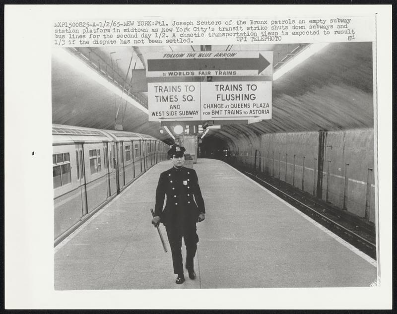 Ptl. Joseph Scutero of the Bronx patrols an empty subway station platform in midtown as New York City's transit strike shuts down subways and bus lines for the second day 1/2. A chaotic transportation tieup is expected to result 1/3 if the dispute has not been settled.