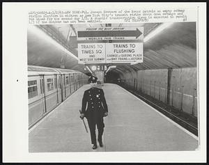 Ptl. Joseph Scutero of the Bronx patrols an empty subway station platform in midtown as New York City's transit strike shuts down subways and bus lines for the second day 1/2. A chaotic transportation tieup is expected to result 1/3 if the dispute has not been settled.