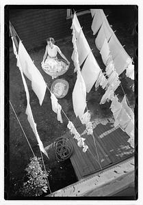 A woman hanging laundry on clotheslines