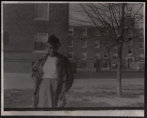 Young woman in fur coat outside Newtowne Court
