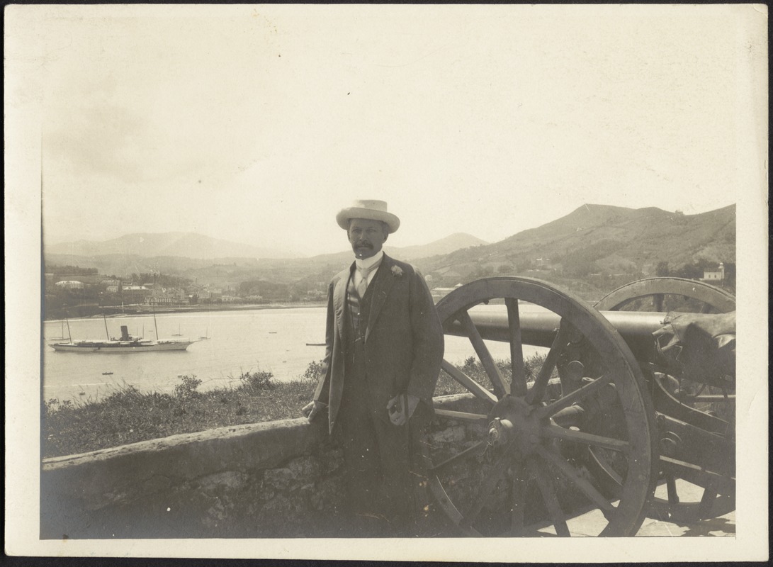 John Gardner Coolidge standing on fort wall near cannon, San Sebastian