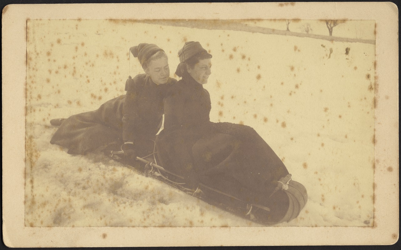 Two women on toboggan in snow, possibly Gertrude Stevens Kunhardt on right