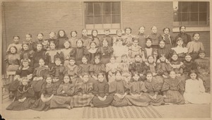 View of schoolgirls seated for class portrait
