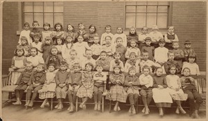 View of school children seated for class portrait