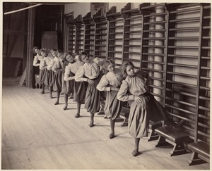 Charlestown High School - eight girls leaning up against wall racks