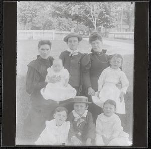 Women and children in a backyard in summer