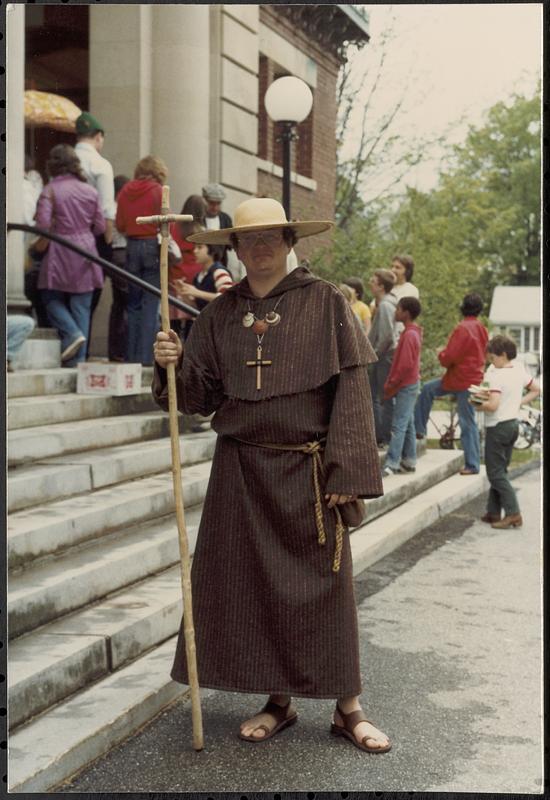 Man dressed as monk, steps Lawrence Library