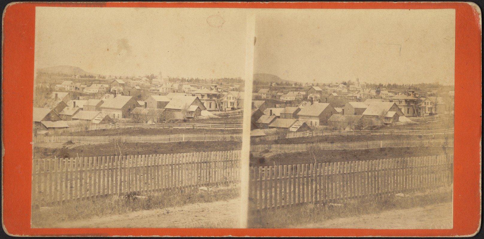 Fenced fields with town beyond