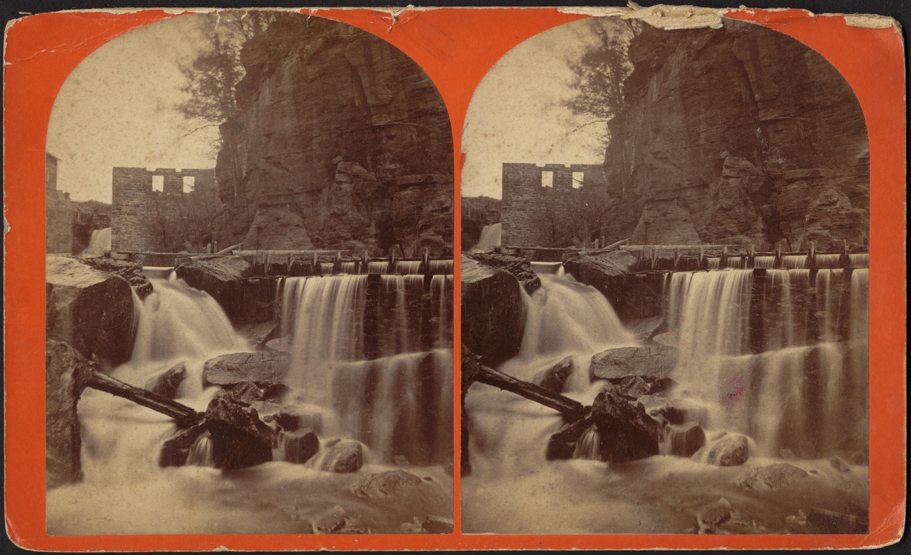 Water falling onto rocks below cliffs