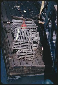 View from above of lobster or fish traps on pier