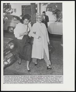 Beverly Aadland's Mother Arrested--Mrs. Florence Aadland, mother of sexy teenager Beverly Aadland, is led to a police car by a police juvenile officer, Sgt. Shirley Maxwell (left), after Mrs. Aadland was arrested at her Hollywood apartment last night on charges of contributing to the delinquency of her daughter. Beverly was a sweetheart of the late Errol Flynn.