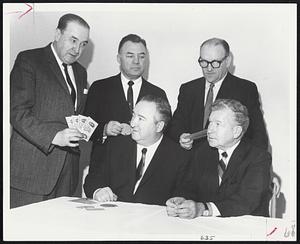 New $50 Tickets for Liston-Clay heavyweight title bout are shown by Boston Garden president Edward Powers to group at Logan Airport motel meeting, Seated, left, promoter Sam Silverman, and state boxing commissioner Herman Greenberg. Standing, state boxing commissioner Eddie Urbec, center, and Bob Nilson of Intercontinental Promotions, Inc. sponsors of bout.