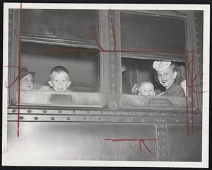 Watchfully Waiting- Passengers on the night train for buffalo and the West, sitting patiently in their seats at the South Station last night. When word of the train strike postponement cam through, their train became a combination of a 7 P.M. Buffalo train and an 8 P.M. Chicago train, which pulled out at 9 P.M. (EDT).