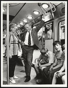 Mayor White riding MTA while opposing fare increase here chatting with Mrs. M. Francis Morill Dorch