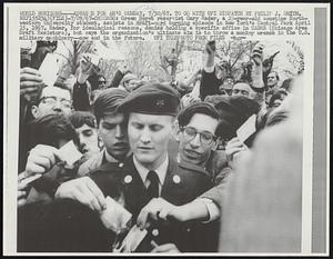 Chicago: Green Beret reservist Gary Rader, a 23-year-old sometime Northwestern University student, assists in draft-card burning episode in New York's Central Park April 15, 1967. Radar, for ideological reasons. denies holding a specific office in CADRE (Chicago Area Draft Resistors), but says the organization's ultimate aim is to throw a monkey wrench in the U.S. military machinery--now and in the future.