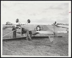 Up and Over-Workmen at Beverly Airport check to see if anyone was aboard this Air Force plane that was turned over on its back when the hurricane struck.