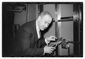 A man demonstrating how to break into a safe