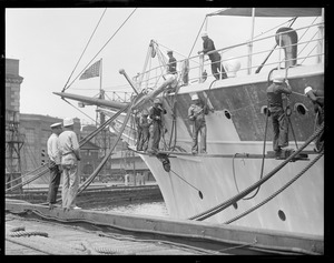Work crew scraping and painting the President's yacht Mayflower in Charlestown Navy Yard