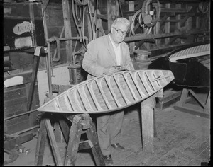 Boat builder Fred Pigeon works on miniature yacht
