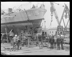Removing damaged rudder of USCG no. 15 Manachan at Navy Yard
