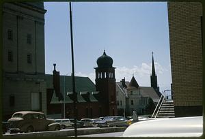 View of dome and steeple, cars in foreground, Butte, Montana