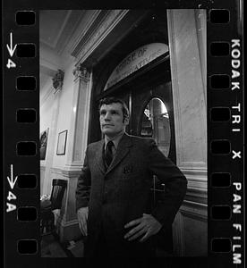 Man standing in front of the entryway to the House of Representatives chamber of the Massachusetts State House