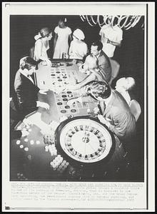 Bahamian Roulette--Tourists gather around a roulette table in one of the casinos at Freeport, Bahamas, that in involved in the impending merger of the Benguet Consolidated, Inc. and the Grand Bahama Port Authority, the development company tied to Bahamas gambling, and partly owned by the Bahamas government.