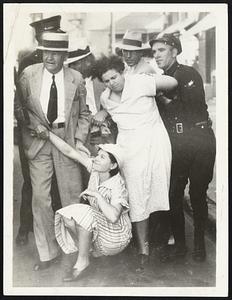 After rioting women strikers at Dallas, Tex., had stripped and spanked four women on the streets, these women pickets of the garment manufacturing industry here are seen being hustled to jail by the police. The women were attacked as they went to work.
